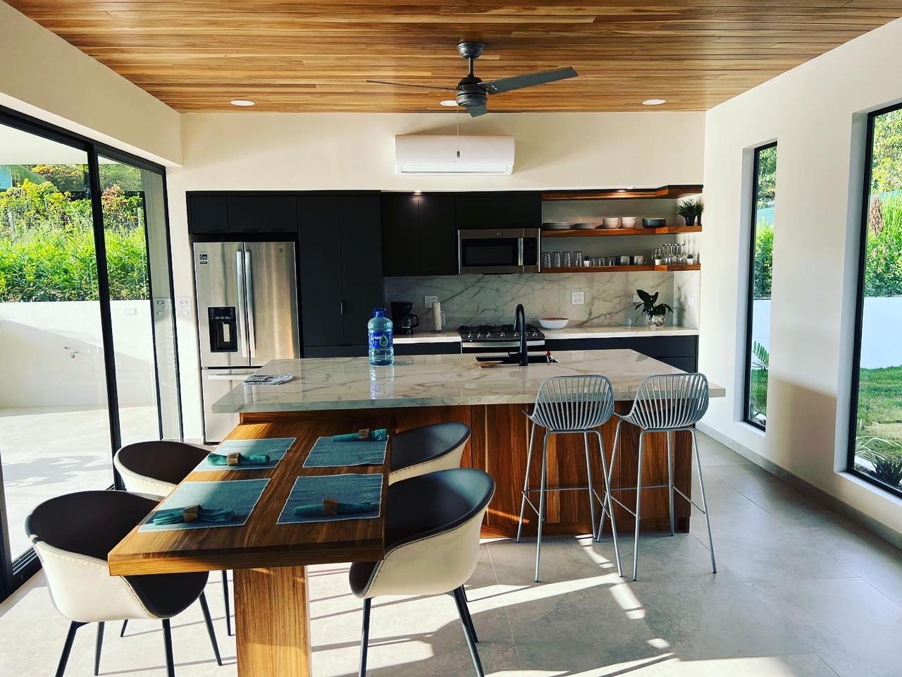 Kitchen and great room with hardwood island and bar seating