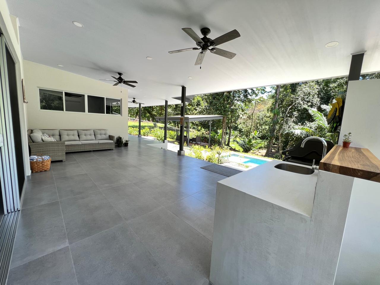 Open-plan living and dining opening onto a pool terrace
