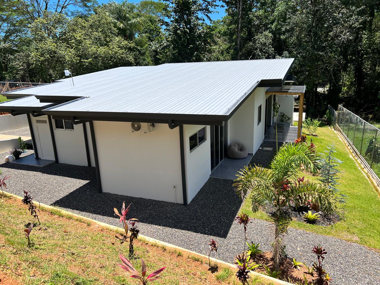 Single-level custom home with covered terrace and landscaping
