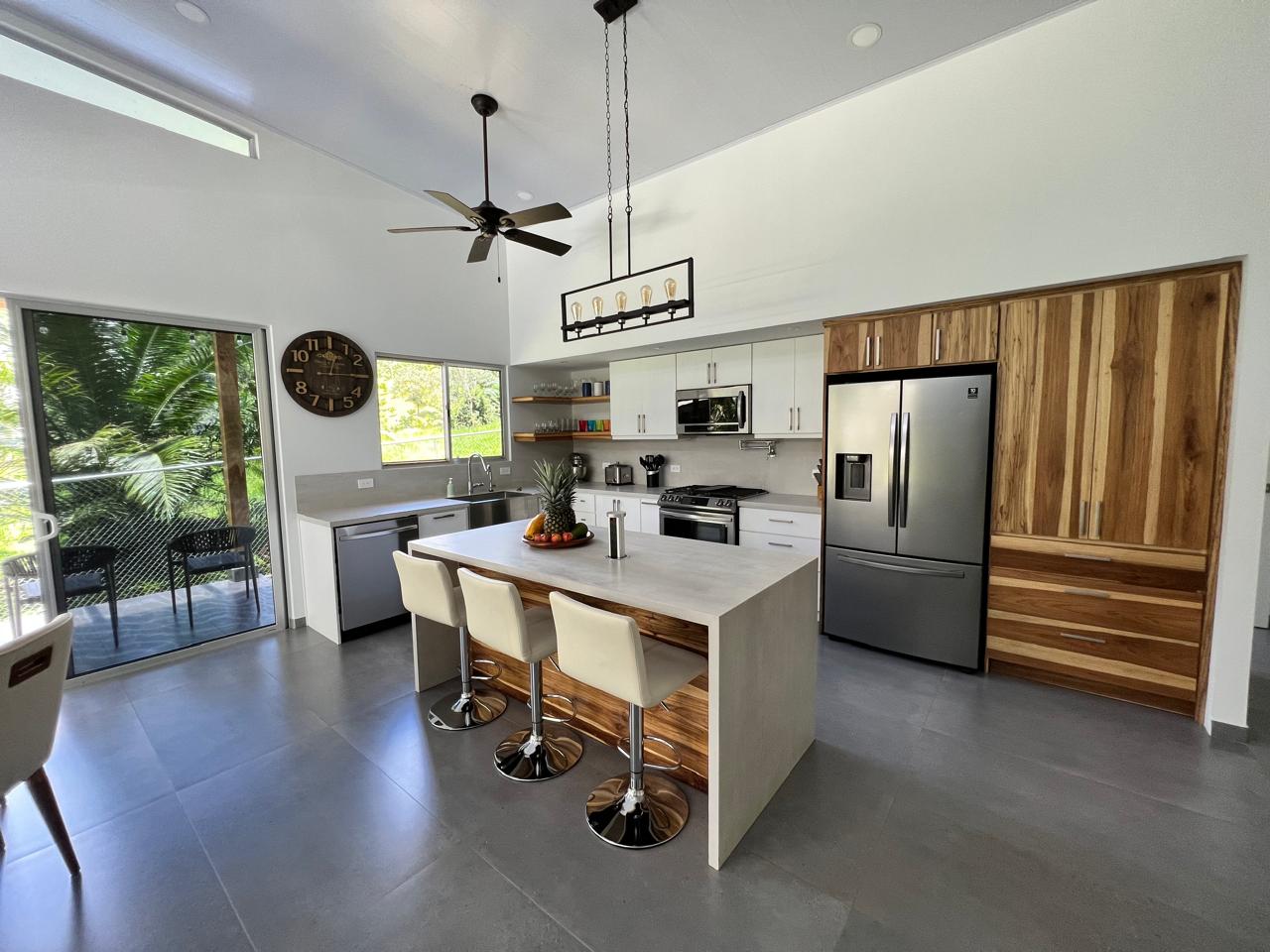 Kitchen island beneath a vaulted ceiling with timber detailing