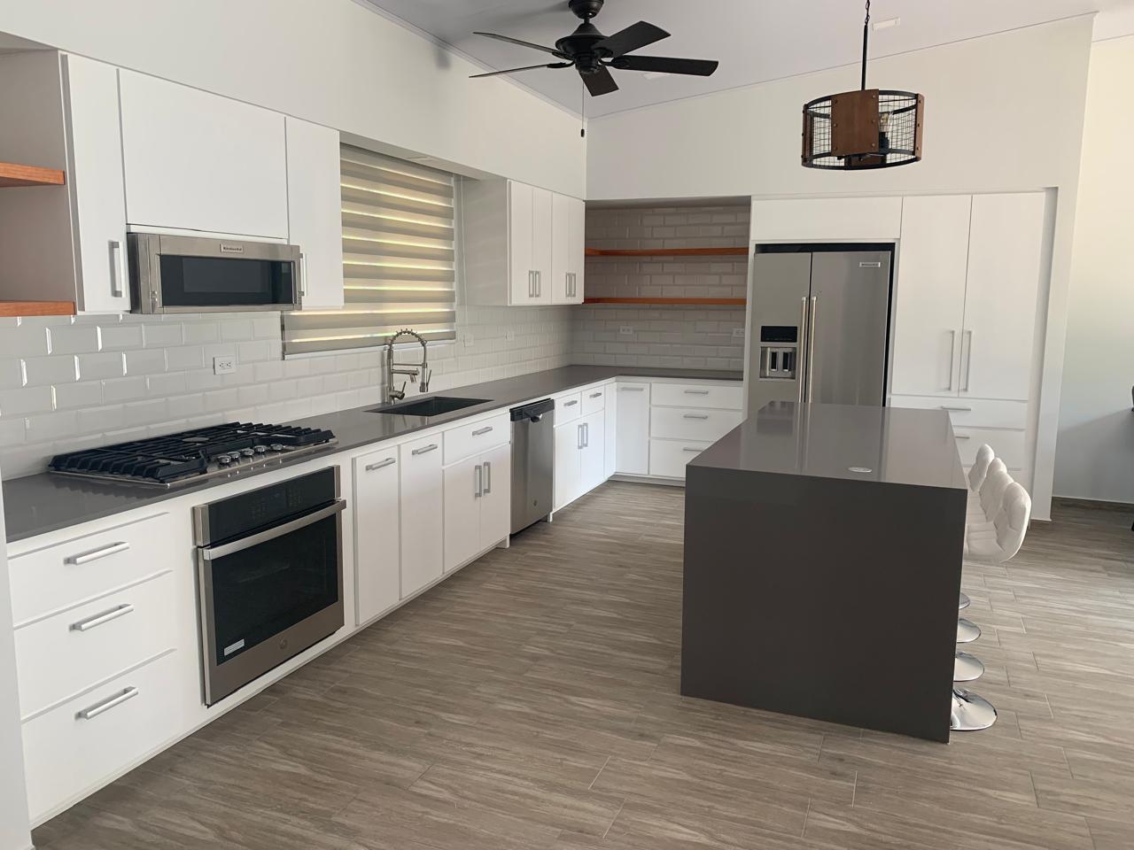 White kitchen fit-out with island and integrated appliances