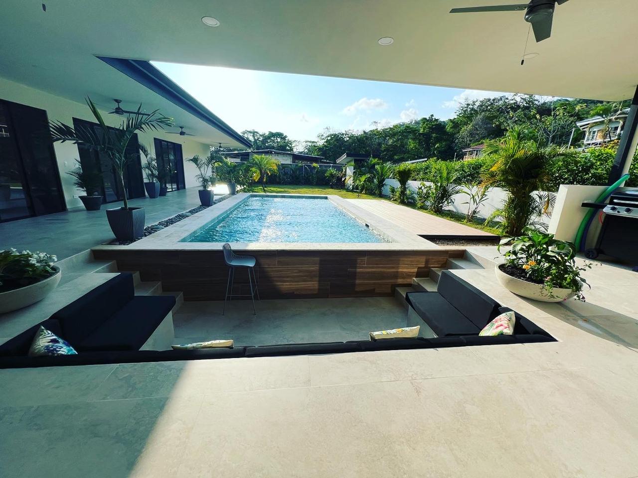 Pool and terrace at dusk at a completed custom home